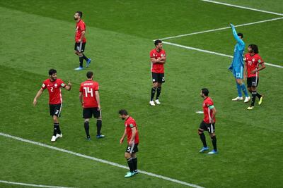 Egypt's players were left dejected by the late goal that lost them the game to Uruguay. Mahmoud Khaled / EPA