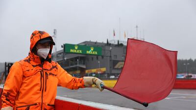 A race marshall waves the red flag as the race is postponed. AFP