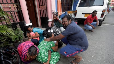 People crouch down as the military try to defuse a suspected bomb in a van before it exploded. Reuters