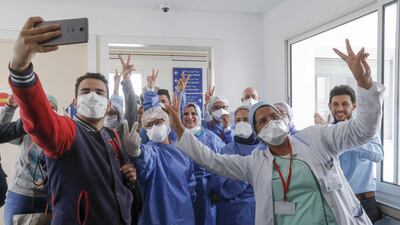 Moroccan patients who recovered from the coronavirus disease celebrate with the medical staff as they leave the hospital in the city of Sale, north of the capital Rabat. AFP