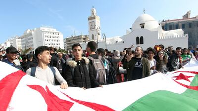 High school students march with a huge national flag in central Algiers. AP