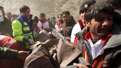 Members of the Iranian Red Crescent carry a body recovered from the wreckage of the prrivate jet which crashed in the mountains around the city of Shahr-e Kord, Iran. Morteza Salehi / EPA