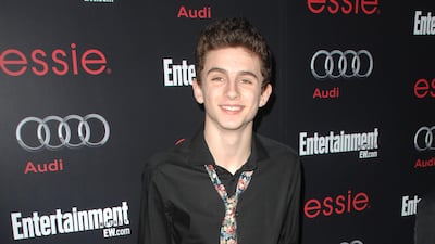 Timothee Chalamet, in a black shirt and floral tie, attends the 'Entertainment Weekly' Screen Actors Guild nominees' party in Hollywood, California, in January 2013. Sipa USA