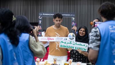 A family celebrates at the iftar hosted by Dar Al Ber Society