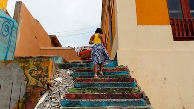 A woman walks up the stairs in the neighbourhood of La Perla. Ricardo Arduengo / AFP