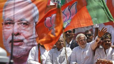 Narendra Modi, the prime ministerial candidate for India's main opposition Bharatiya Janata Party, waves to supporters as he arrives to file his nomination papers for the general elections in the northern city of Varanasi on April 24, 2014. Adnan Abidi / Reuters