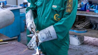 A worker welds stainless steel rods. With a 1,600-strong workforce, Gulf Craft churns out on average 400 boats a year.