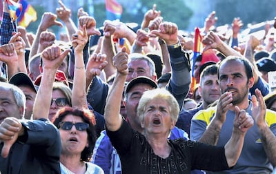 Supporters of Armenian protest leader Nikol Pashinyan react as they watch a live broadcast of the extraordinary session of parliament to elect a new prime minister in Yerevan on May 1, 2018. AFP
