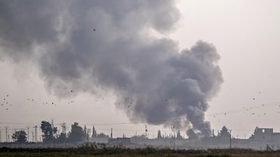 Smoke rises from the Syrian town of Tal Abyad after Turkish bombings, in a picture taken from the Turkish side of the border near Akcakale in the Sanliurfa province. AFP