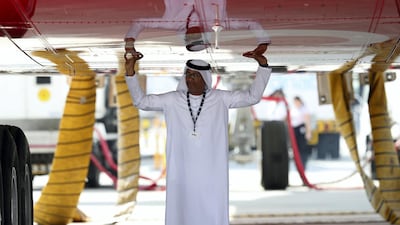 A visitor under an A380 at the Dubai Airshow on Tuesday, November 14, 2017. Chris Whiteoak / The National