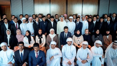 Sheikh Hazza bin Zayed stands for a photograph with UAE students who are studying in Japan. Rashed Al Mansoori / Ministry of Presidential Affairs