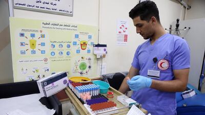 A medic at the Palestinian Red Crescent Hospital in the West Bank city of Hebron. About 30 per cent of Palestinians have received at least one Covid-19 vaccine dose. EPA
