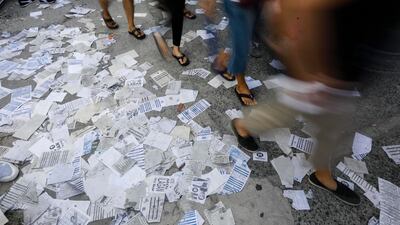 Flyers resembling sample ballots are scattered at a school used as a voting centre in the Cainta town of Rizal province. EPA