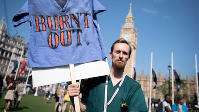 A striking junior doctor takes part in a rally in Parliament Square, central London, during a 72-hour stoppage in a row with the government over pay. PA