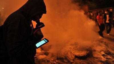 A protester in Istanbul uses Facebook on mobile phone to give latest news about the clashes near Taksim this week.