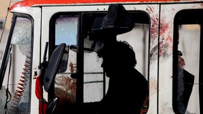An official removes a police vehicle from the scene of a suicide bomb blast near the police administration building, in Kabul, Afghanistan. Hedayatullah Amid / EPA