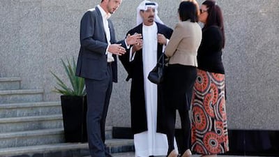 Rebecca Blake (2nd R) and Conor McRedmond (L) stand with their lawyer Shaker Al Shummari (2nd L) outside the Dubai Courts. Reuters / /Jumana El Heloueh