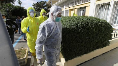 Medics walk outside a clinic where the flight crew as well as several people who were in contact with an Italian man who tested positive for COVID-19 in Algeria. AP