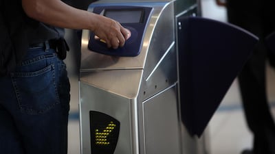 A passenger scans his Nol card at Dubai Metro. Touchless payments will become more common in the future according to transport experts. Amy Leang / The National