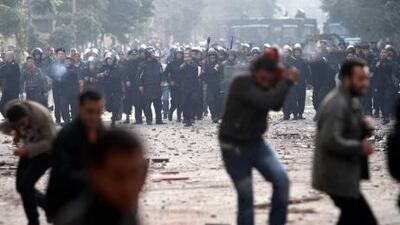 Protesters clash with riot police in Cairo yesterday as thousands of anti-regime demonstrators continue to pour onto Cairo's streets.
