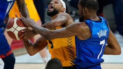 Patty Mills, who top-scored for Australia, drives to the basket against USA's Kevin Durant. AP