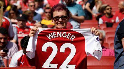 A fan poses with an Arsenal shirt, displaying text to thank Arsene Wenger during the Premier League match between Arsenal and West Ham United at Emirates Stadium on April 22, 2018. Shaun Botterill / Getty Images