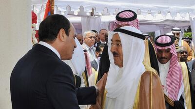 Kuwait’s Emir Sheik Sabah Al Ahmad Al Jaber Al Sabah greets Egyptian president Abdel Fattah El Sisi, left, at the ceremony where he was sworn in on Sunday for a four-year term. Mena news agency/AP Photo