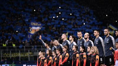 Inter Milan's goalkeeper Samir Handanovic, centre, and teammates stand at attention. AFP