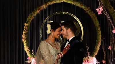 Newlyweds Priyanka Chopra, 36, and Nick Jonas, 26, pose for a photograph during a reception at a hotel in New Delhi on December 4, 2018. Photo: AFP