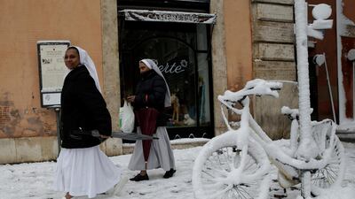 Nuns walk past a bike covered in snow during a heavy snowfall in Rome, Italy on February 26, 2018. Max Rossi / Reuters