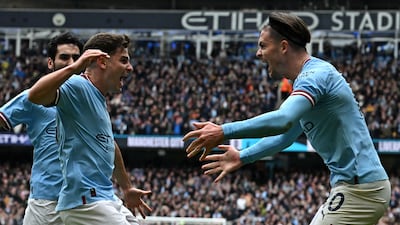 Manchester City's Julian Alvarez, left, celebrates with Jack Grealish after scoring. AFP
