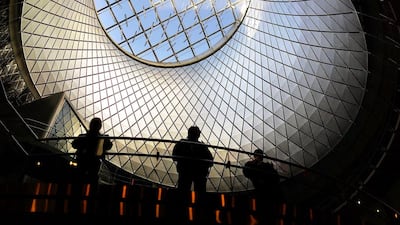Commuters walk through the newly opened Fulton Center train station in lower Manhattan on November 10, 2014 in New York City. The station was scheduled to open in 2007 as part of the rebuilding effort of lower Manhattan after 9/11, but the project ran into cost overruns and years of delays. The original plan for the facility, which has a glass and steel shell and 66,000 square feet of retail and office space, was projected at $750 million and nearly doubled to $1.4 billion before it was finished. The station features a 10-foot-high glass opening, or oculus, which sits above an atrium that lets sunlight down into two levels below street level. The station makes it easier to connect between nine subway lines: the A, C, J, Z, R, 2, 3, 4, and 5. Riders will eventually also be able to connect to the E and 1 trains. Spencer Platt / Getty Images / AFP