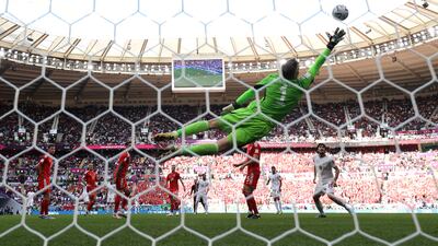 Wayne Hennessey of Wales jumps to defend an Iran attempt at goal at the Ahmad Bin Ali Stadium. Getty