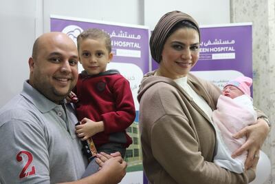 Ahmed Khalifa holds his son, Marwan, while Dr Hala Ali Hassan cuddles newborn Jannat at Bareen International Hospital. Bareen