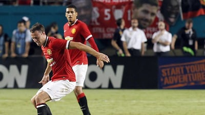 Jonny Evans, left, of Manchester United fights for control of the ball against Phillipe Coutinho of Liverpool on August 4, 2014 during the championship match in the 2014 Guinness International Champions Cup at Sun Life Stadium in Miami, Florida. Manachester Untied won 3-1. AFP PHOTO/Robert SULLIVAN