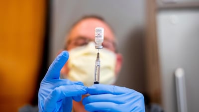 A pharmacist draws saline while preparing a dose of Pfizer's Covid-19 vaccine in Sacramento, California. AP Photo