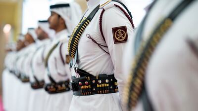 A Qatari honour guard greets Sheikh Mohamed at the airport