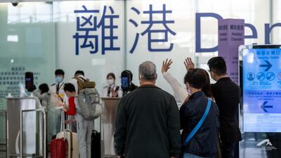 People wave in the departures hall at the Hong Kong International Airport in Hong Kong, China. Bloomberg