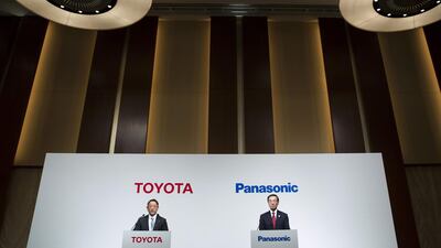 Akio Toyoda, president of Toyota Motor, left, and Kazuhiro Tsuga, president of Panasonic, are exploring a joint business to develop power equipment for zero-emission vehicles. Tomohiro Ohsumi/Bloomberg