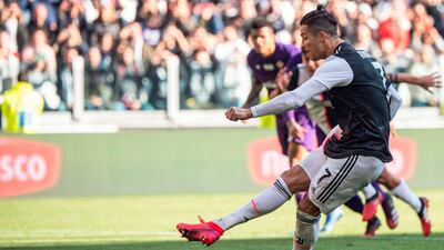 Cristiano Ronaldo scores from the penalty spot against Fiorentina on Sunday. AFP