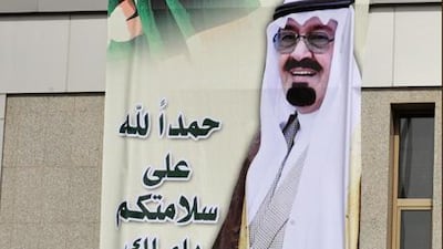 A huge poster of King Abdullah bin Abdul Aziz that reads in Arabic, 'Thank God for your safety, king of hearts'.