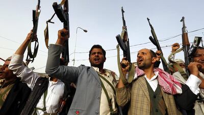 Houthi supporters raise their guns aloft while shouting anti-Saudi slogans during a rally protesting airstrikes carried out by a Saudi-led coalition against Houthi rebels in Yemen. Yahya Arhab / EPA