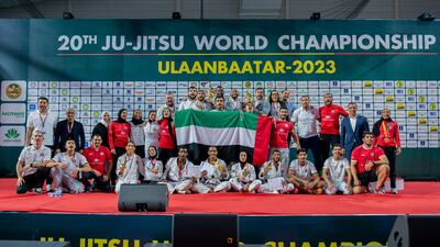 UAE captain Faisal Al Ketbi and team official Mubarak Al Menhali share the podium with the championship trophy. Photo: UAEJJF