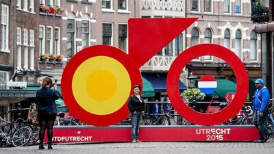 People take pictures by decorations set for the upcoming Tour de France cycling race in downtown Utrecht. Robin van Lonkhuijsen / AFP / June 23, 2015