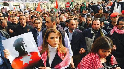 Jordan’s Queen Rania, centre, after midday prayers yesterday joined thousands of demonstrators on the streets of the Jordanian capital Amman to express their solidarity with the air force pilot burnt to death by militants. Queen Rania’s Office / AFP