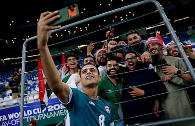 Iraq's Ibrahim Bayesh takes a selfie with fans at the Estadio BBVA in Monterrey, Mexico. Reutes