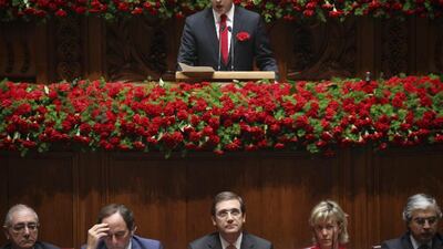 General Secretary of Portuguese Socialist Party, Antonio Jose Seguro (C, back row), delivers his speech accompanied by (L-R, front row) Portuguese Minister for Foreign Affairs Rui Machete, Vice-Prime Minister Paulo Portas, Prime minister Pedro Passos Coelho, Minister of Finance Maria Luis Albuquerque and Minister of Defense Aguiar Branco, during the hommage of the 40th anniversary of Carnations ceremony at Portuguese Parliament, in Lisbon. Mario Criuz / EPA / April 25, 2014