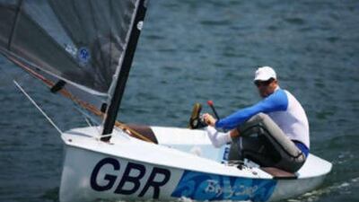Finn class sailor Ben Ainslie of Great Britain leaves the marina on his way to practice at the Qingdao Olympic Sailing Center.