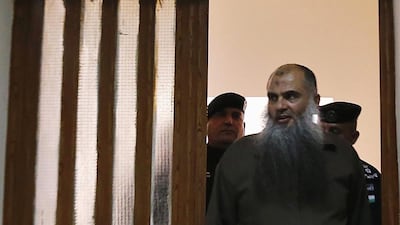 Radical Muslim cleric Abu Qatada enters the hall to the State Security Court in Amman June 26, 2014, where he was acquitted of conspiring to commit acts of terrorism. The cleric, who was extradited from Britain after a lengthy legal process, will continue to be held because of separate charges related to a plot to attack tourists during Jordan’s New Year celebrations in 2000. Muhammad Hamed/Reuters