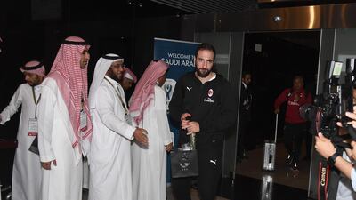 AC Milan striker Gonzalo Higuain gets off the team bus at Jeddah King Abdulaziz International Airport. Getty Images
